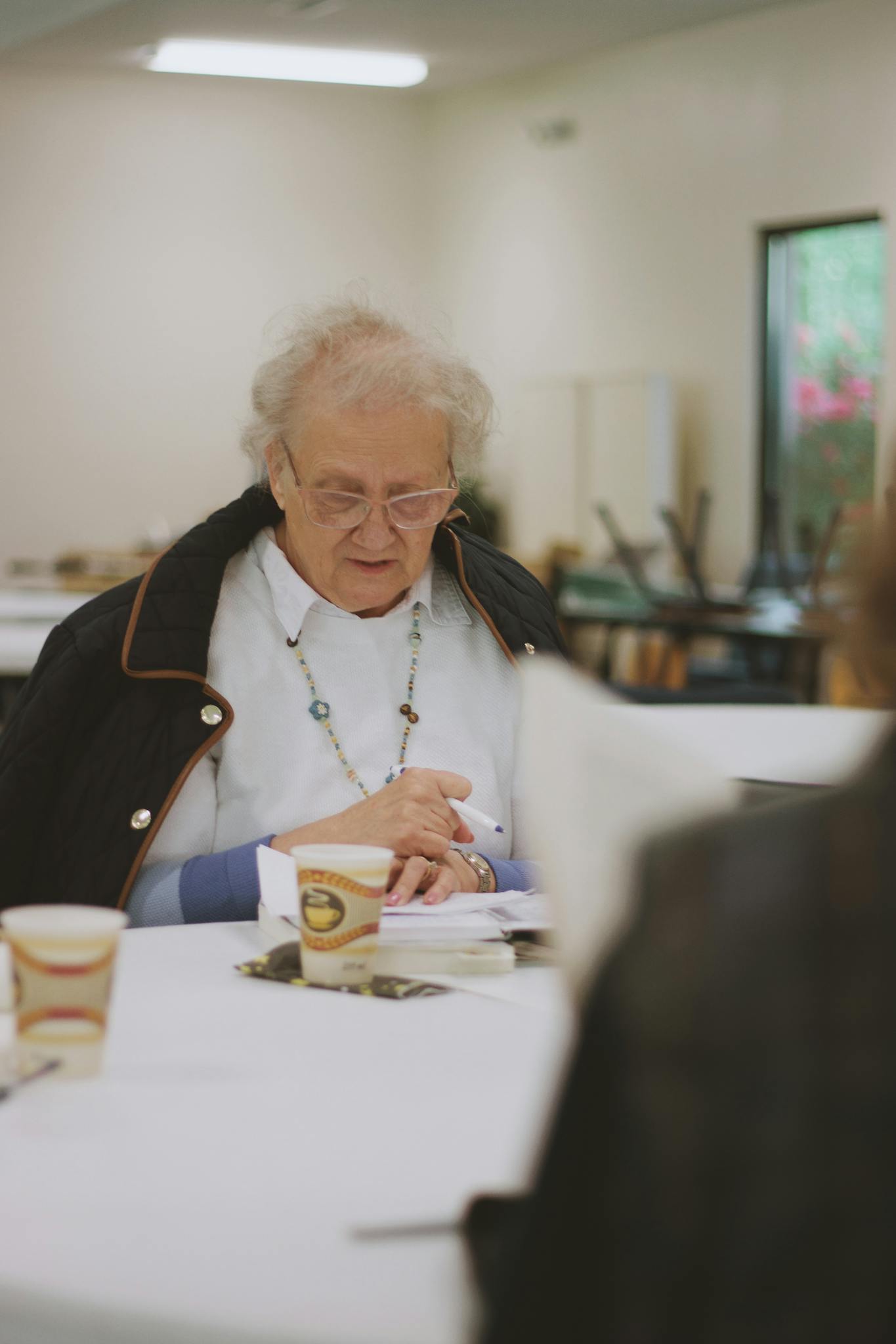 Elderly woman participating in a Bible study at a community church in Brevard, NC.